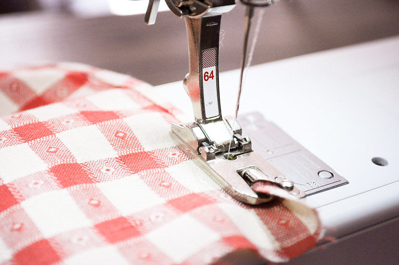 Bernina #64 hemmer foot rolling a kerchief hem.