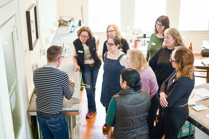 Ron Collins Teaching aGarment Workshop in Parkdale Toronto with students listening